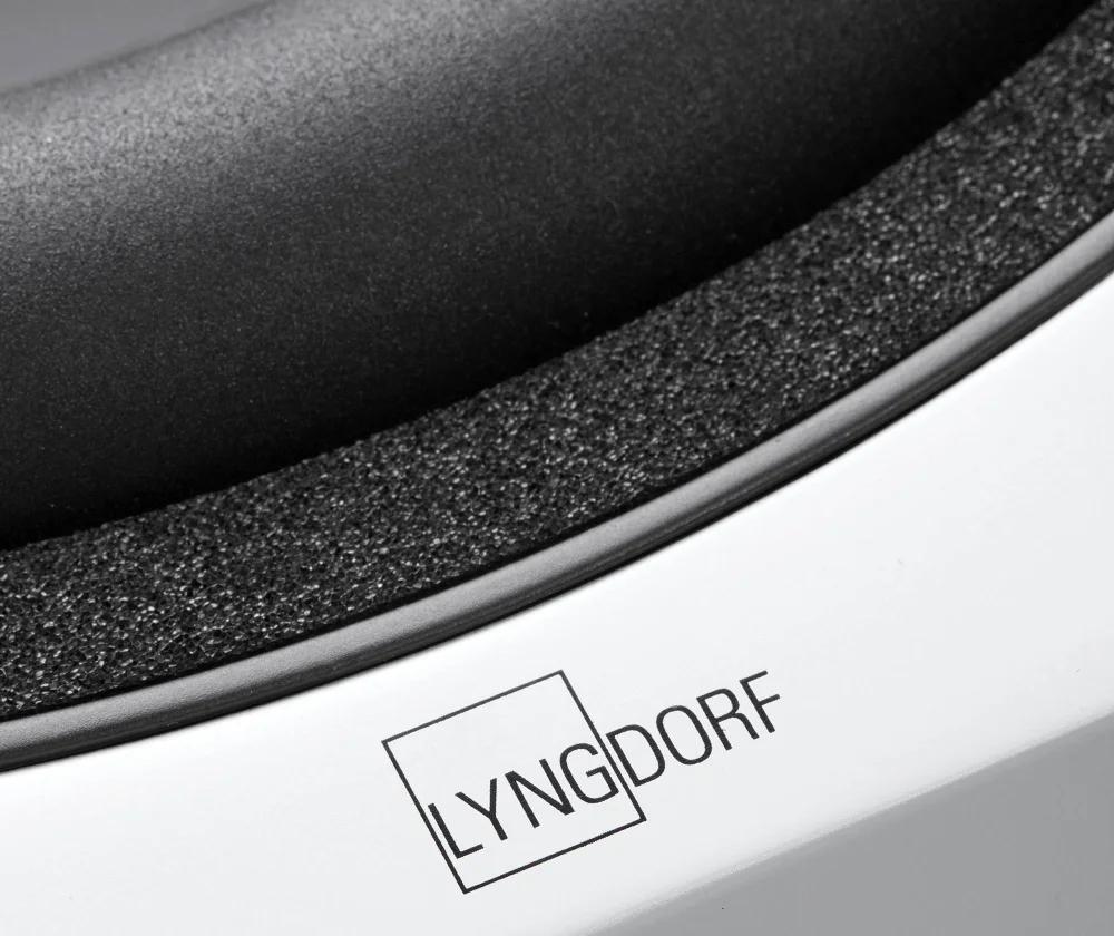 The Lyngdorf BW-2 subwoofer driver is shown in extreme close-up, revealing the suspension and absorption material between the suspension and the cabinet, as well as the Lyngdorf logo on the cabinet.