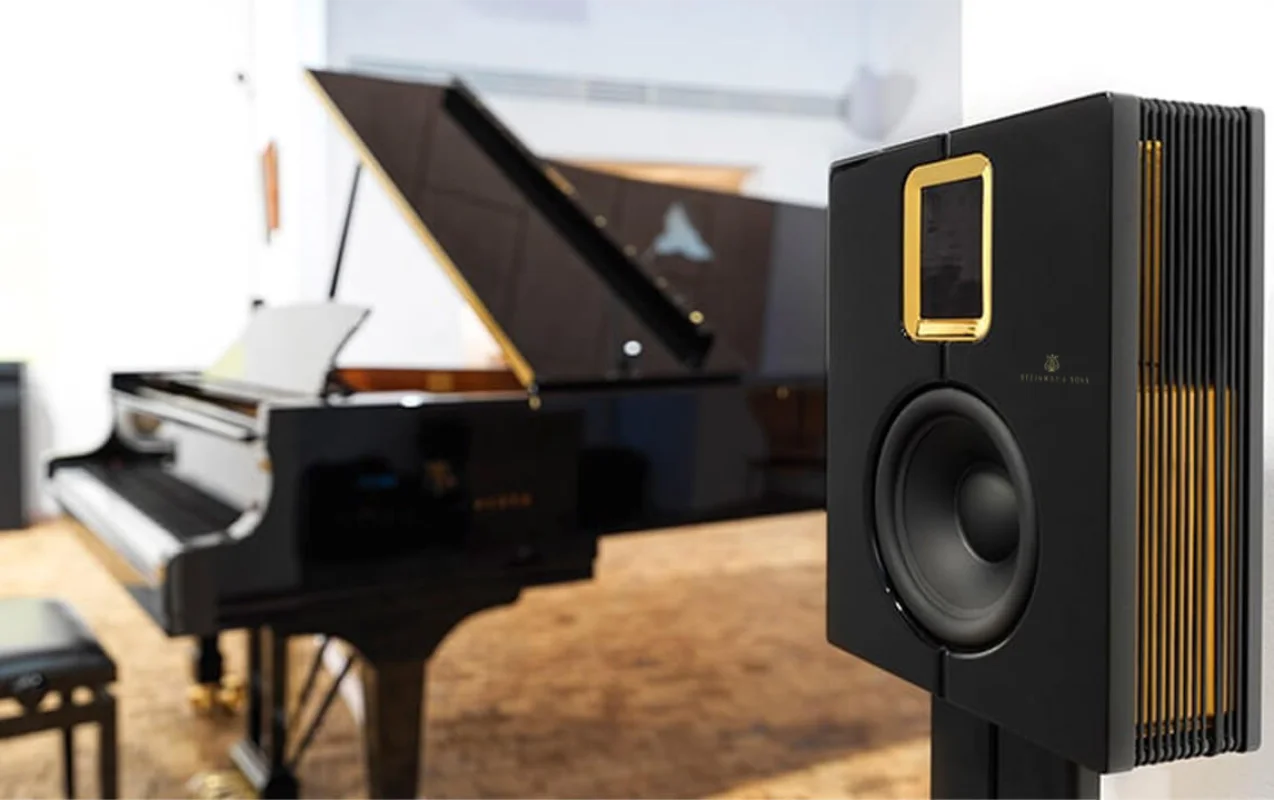 Model S-15 loudspeaker on a stand next to a Steinway S-155 grand piano