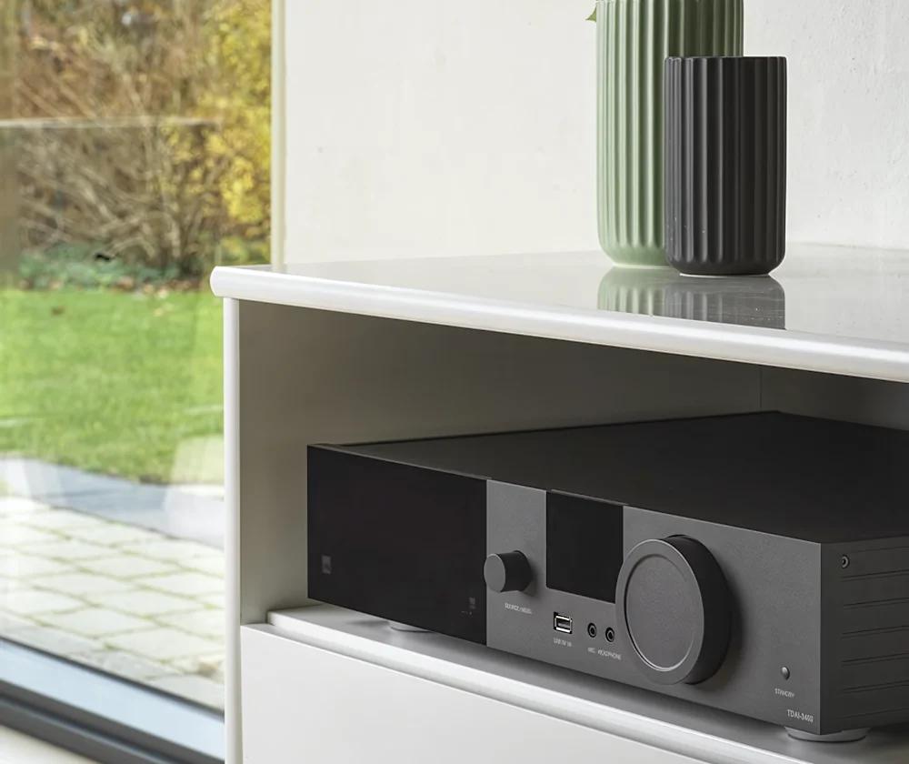 Close-up of the niche in the white TV stand shelf, which houses the Lyngdorf TDAI-3400 streaming amplifier.