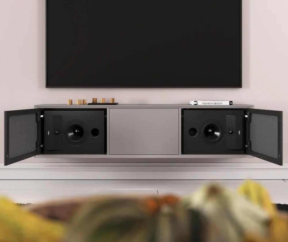 A three-section cabinet housing a pair of Lyngdorf CS-2 loudspeakers (the doors with acoustically transparent panels are open for demonstration purposes) and a large television above the cabinet.